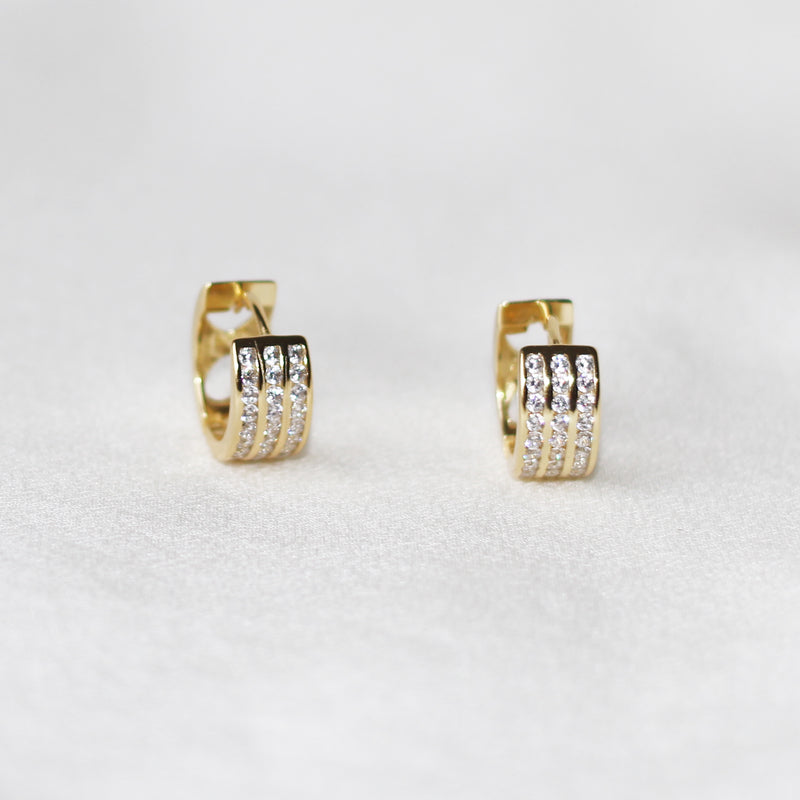 Luv AJ pave Amalfi 14k gold plated huggie hoop earrings with emerald  crystals | ASOS
